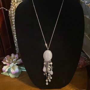 Whimsical dangle pendant with silver accents and silver chain.